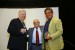 Professor T. Grandon Gill, Chair of the Award Ceremony, and Dr. Nagib Callaos, General Chair, giving Dr. Karl Müller, a plaque "In Appreciation for A Great Keynote Address at a Plenary Session."